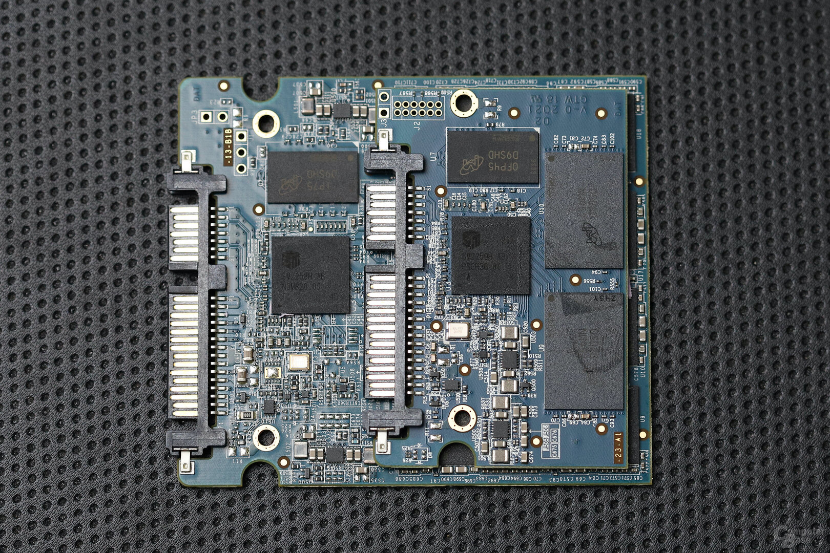 Crucial MX500 1 TB: PCB-Rückseite der Varianten mit Firmware M3CR010 und M3CR033 (oben) im Vergleich